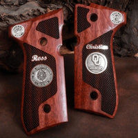 Beretta 92FS grips made of Rosewood with custom logos and text made of silver..