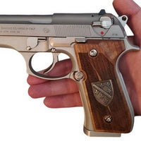 Beretta 92FS grips made of walnut wood with custom logos made of silver.