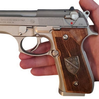 Beretta 92FS grips made of walnut wood with custom logos made of silver.1