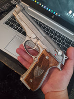 Beretta 92FS grips made of walnut wood with custom logos made of silver.8