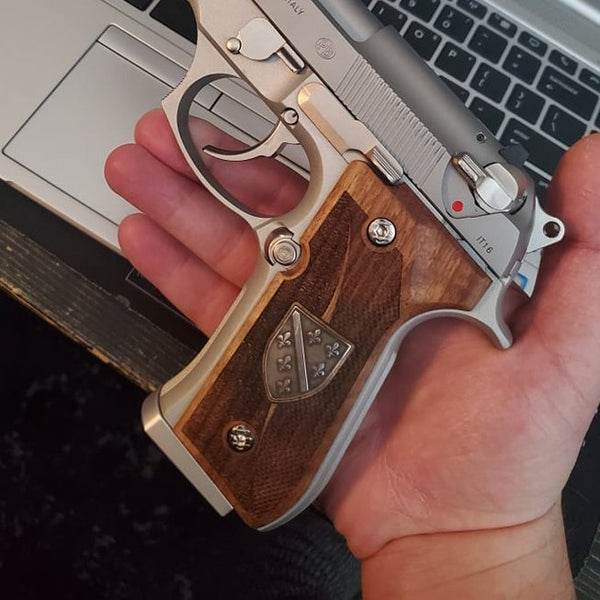 Beretta 92FS grips made of walnut wood with custom logos made of silver.left