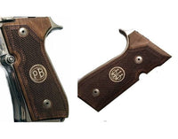 Beretta 92FS grips made of walnut wood with custom logos made of silver.