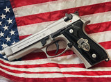 Black acrylic Beretta M9A1 custom pistol grips with silver custom logo, designed for improved grip and aesthetic appeal.