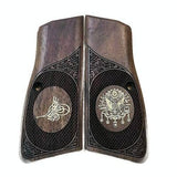 Browning Hi-Power custom grips made of walnut wood with silver logo accents on a pistol grip surface.
