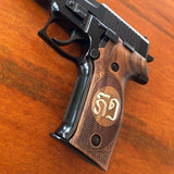 Sig Sauer M11-A1 custom walnut wood grips with silver logo inlay for enhanced firearm style and grip comfort.