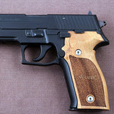 Sig Sauer M11-A1 pistol with custom walnut wood grips engraved with Sig Sauer and "11" model number.