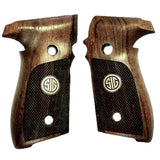 A pair of wooden pistol grips with dark textured panels and a circular SIG logo in the center, shown on a plain white background.