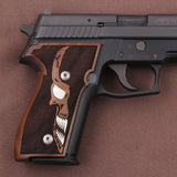 Walnut wood Sig Sauer P226 custom grips with silver skull inlay, designed for improved grip and a distinctive look.