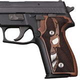 Sig Sauer P226 custom grips made from walnut wood with silver skull inlay, designed for enhanced grip and style.