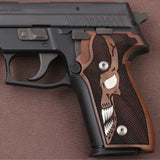 Sig Sauer P226 custom walnut wood grips with silver skull inlay, designed for enhanced grip and style.