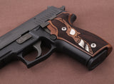 Sig Sauer P226 custom grips made from walnut wood with silver skull inlay, designed for enhanced grip and aesthetic appeal.