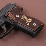 Sig Sauer P229 custom walnut wood grips with brass logo inlay for enhanced firearm grip and aesthetic appeal.