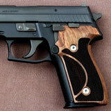 Sig Sauer P226 Legion custom grips made from walnut wood, showcasing detailed craftsmanship and natural wood grain.