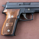 Walnut wood Sig Sauer P228 custom grips with dragon skin checkering and engraved logo for enhanced grip and style.