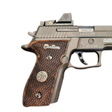 Walnut wood Sig Sauer P228 custom grips with silver logo and inlay, designed for enhanced grip and aesthetic appeal.