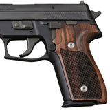Close-up of Sig Sauer P228 custom grips with textured black surface, designed for improved handling and grip.