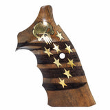 A wooden grip cover for a handgun featuring a dark wood striped pattern, gold star inlays, a gold skull emblem, and a central hole, shown on a plain white background.