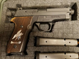 Sig Sauer M11-A1 custom walnut grips with silver logo and text for handgun, showcasing detailed wood grain and sleek finish.